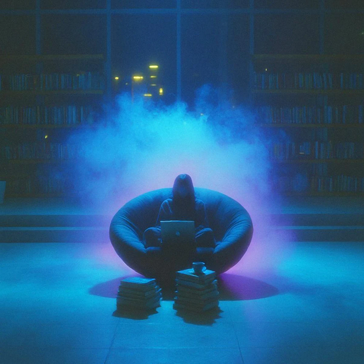 Soft Focus album cover — a figure in a beanbag chair with a laptop, lit blue in a library at night